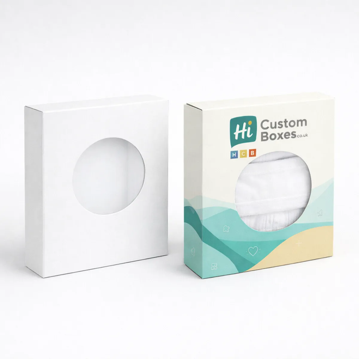 Two white rectangular retail boxes with hanging tabs- featuring a teal and sand-coloured wave design- class=
